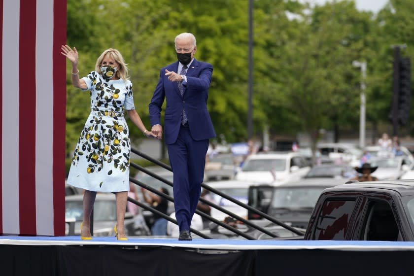 President Joe Biden and first lady Jill Biden arrive for a rally at Infinite Energy Center, to mark his 100th day in office, Thursday, April 29, 2021, in Duluth, Ga. (AP Photo/Evan Vucci)