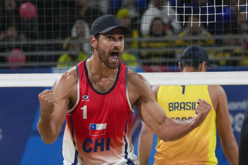 Chile's Marco Grimalt celebrates a point during a men's beach volleyball semifinal match against Brazil at the Pan American Games in Santiago, Chile, Thursday, Oct. 26, 2023. (AP Photo/Esteban Felix)