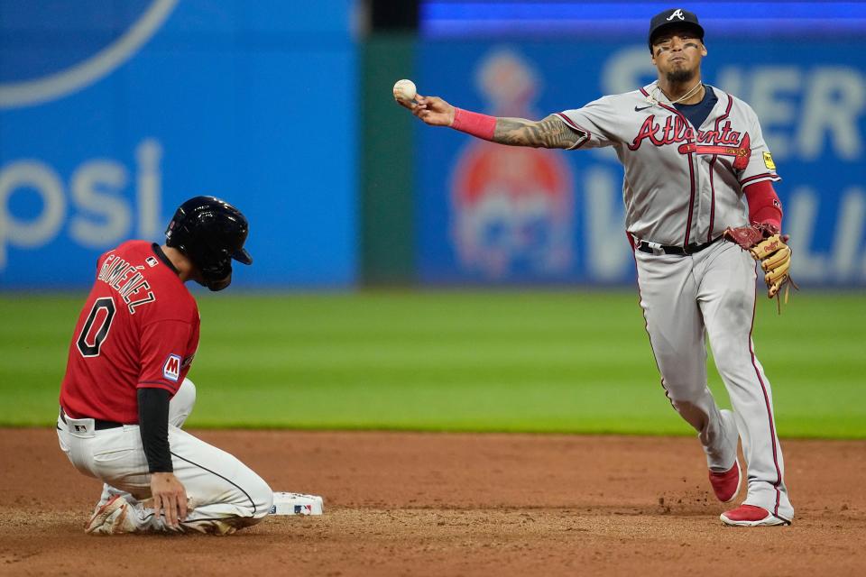 Atlanta Braves shortstop Orlando Arcia throws to first after forcing out Cleveland Guardians' Andres Gimenez at second base on a double play hit into by Josh Bell during the seventh inning of a baseball game Wednesday, July 5, 2023, in Cleveland. (AP Photo/Sue Ogrocki)