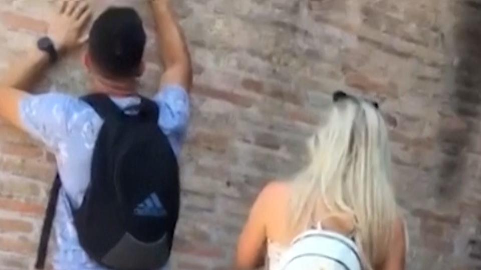 Officials in Italy have vowed to find and punish a person filmed carving his and his significant other's name in the wall of the Colosseum in Rome.