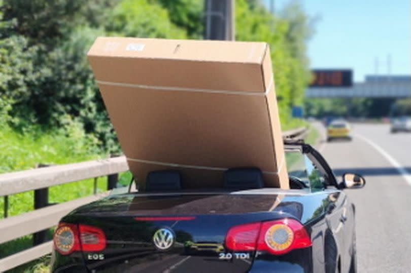 The car with the 60-inch wide television in the back on the M60 around Manchester