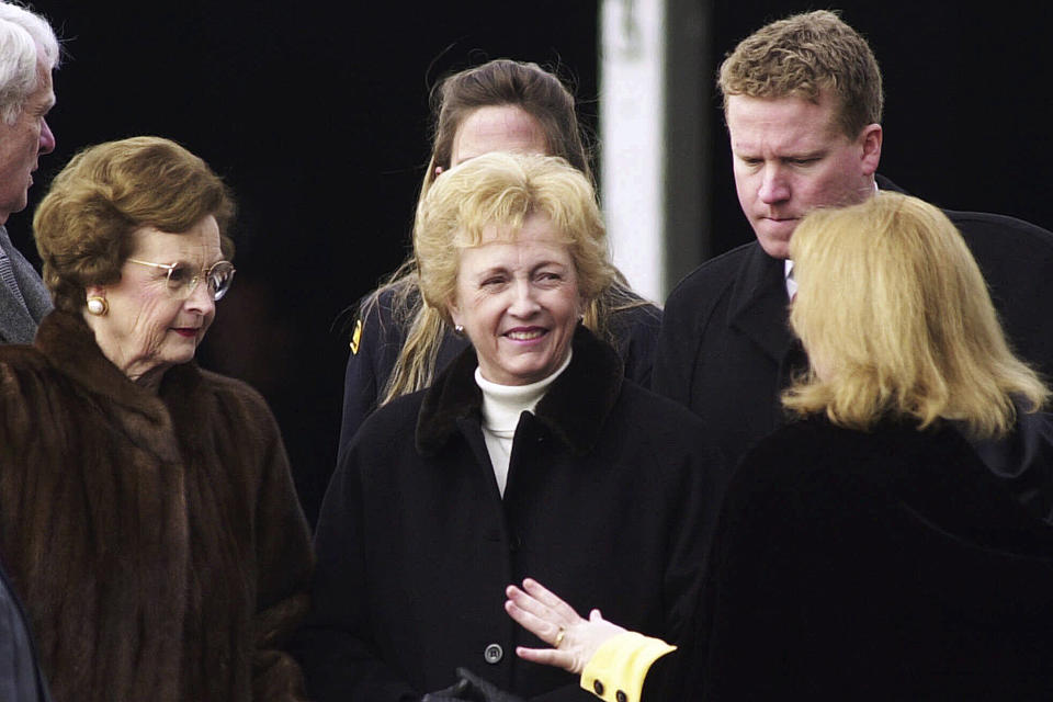 FILE - Sen. Jean Carnahan, D-Mo, center, talks with her daughter-in-law Deborah Carnahan, right, front, as she stands with her son, Tom Carnahan, back right, and former Missouri first lady Betty Hearnes, left, Monday, Jan. 8, 2001, prior to the inaugural ceremonies in Jefferson City, Mo. Carnahan, who became the first female senator to represent Missouri after she was appointed to replace her husband following his death, died Tuesday, Jan. 30, 2024. She was 90. (AP Photo/L.G. Patterson, File)