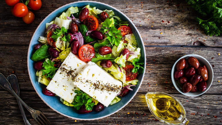 Greek salad in bowl on surface 