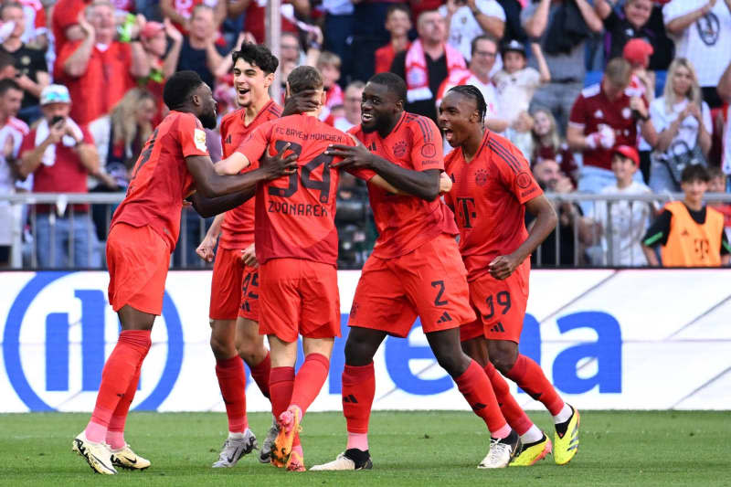 Munich's Lovro Zvonarek (C) celebrates scoring his side's first goal with teammates during the German Bundesliga soccer match between Bayern Munich and VfL Wolfsburg at Allianz Arena. Lukas Barth/dpa