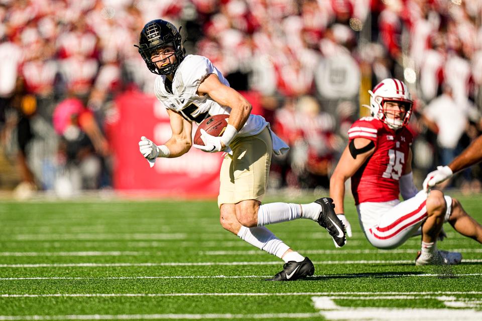 Purdue wide receiver Charlie Jones (15) runs against Wisconsin safety John Torchio during the first half of an NCAA college football game Saturday, Oct. 22, 2022, in Madison, Wis. (AP Photo/Andy Manis)