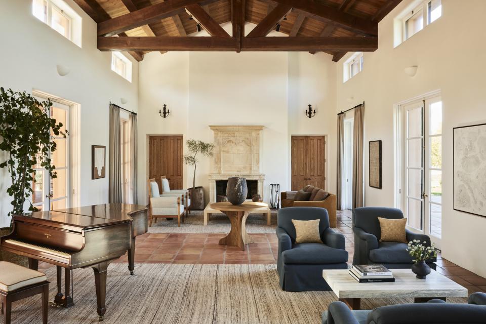 A living room with wooden beams and colored furniture