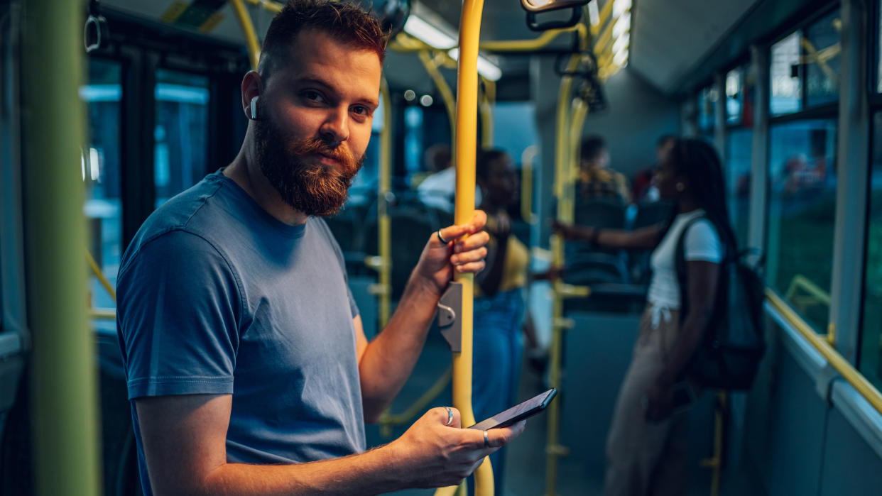  AirPods Pro worn by a bearded man, on public transport 