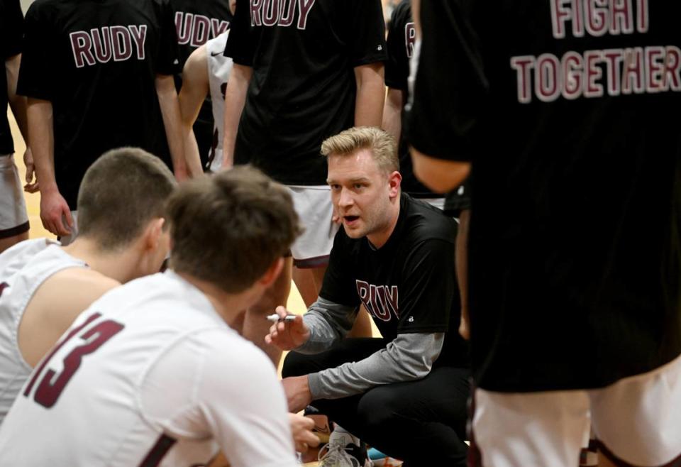 State College boys basketball coach Brian Scholly talks to his players before the game against Cumberland Valley on Tuesday, Feb. 7, 2023.