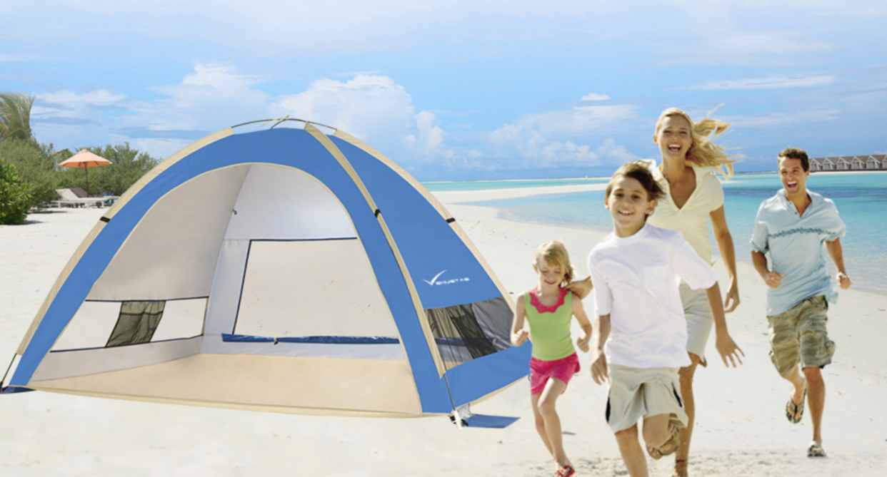 blonde woman running with children and man on beach with blue beach tent, beach tent