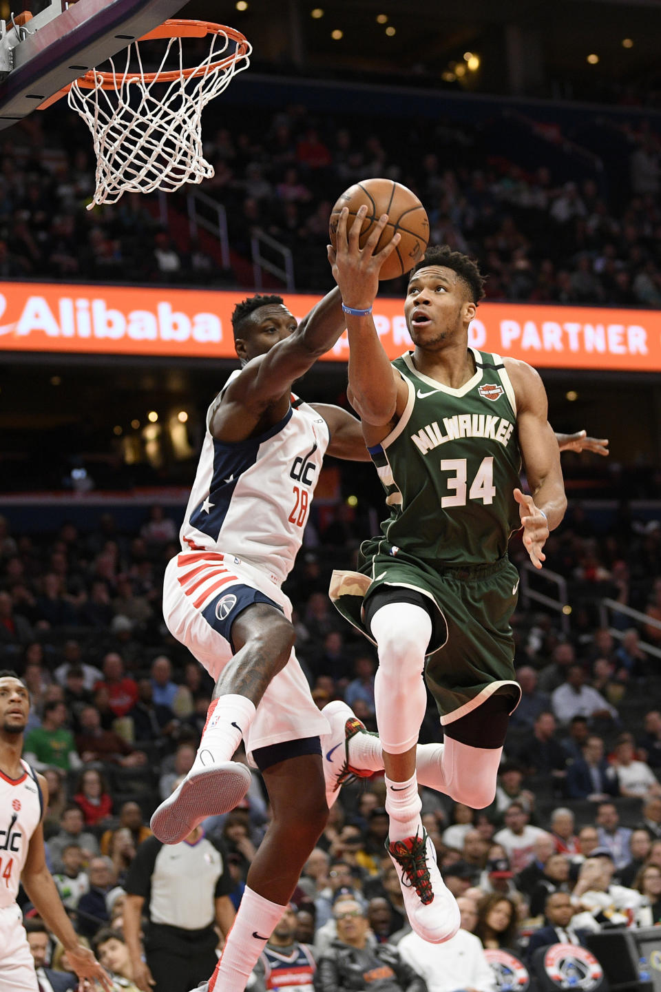 Milwaukee Bucks forward Giannis Antetokounmpo (34) goes to the basket against Washington Wizards center Ian Mahinmi, left, during the first half of an NBA basketball game, Monday, Feb. 24, 2020, in Washington. (AP Photo/Nick Wass)