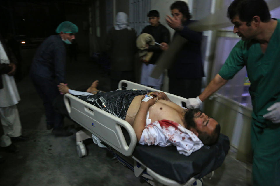 A man injured in a suicide bombing is brought into a hospital in Kabul, Afghanistan, Nov. 20, 2018. Afghan officials said the suicide bomber targeted a gathering of Muslim religious scholars in Kabul, killing at least tens of people. A Public Health Ministry spokesman said another 60 people were wounded in the attack, which took place as Muslims around the world marked the birthday of the Prophet Mohammad. (AP Photo/Rahmat Gul)