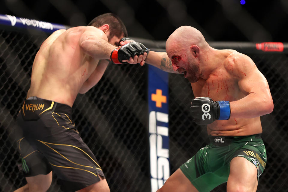 Alex Volkanovski (pictured rigtht) throws a punch at Islam Makhachev (pictured left) in their UFC fight.