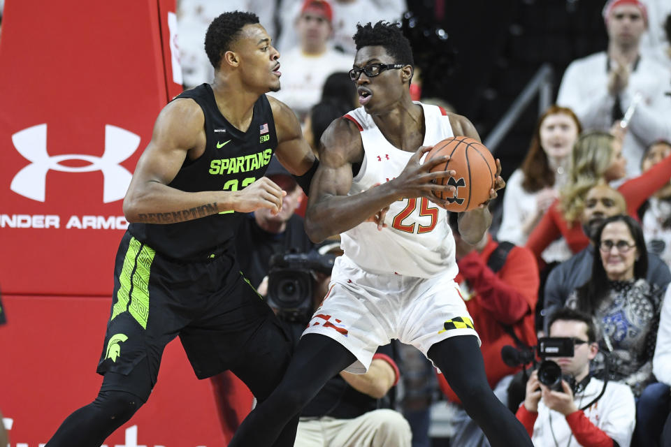 Maryland forward Jalen Smith (25) handles the ball against Michigan State forward Xavier Tillman Sr. (23) during the first half of an NCAA college basketball game Saturday, Feb. 29, 2020, in College Park, Md. (AP Photo/Terrance Williams)