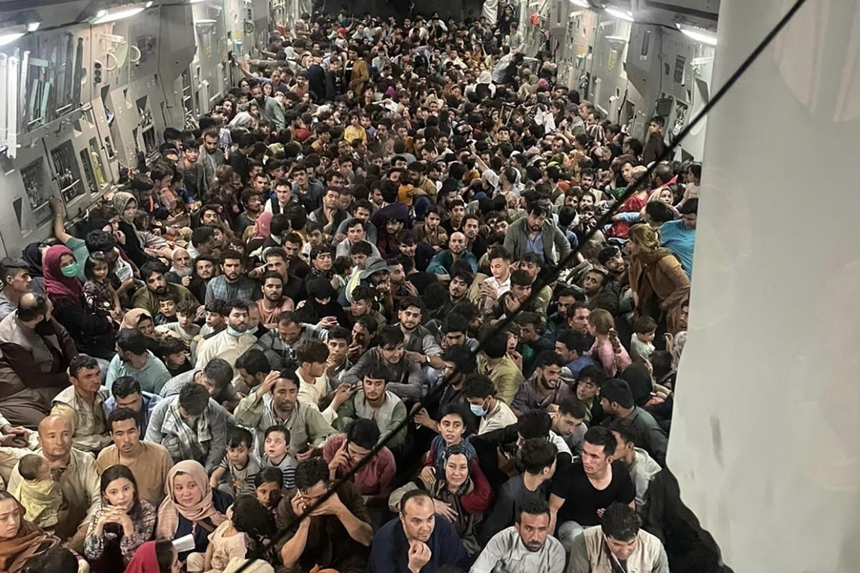 TOPSHOT - This image distributed Courtesy of the US Air Force shows the inside of Reach 871, a U.S. Air Force C-17 Globemaster III flown from Kabul to Qatar on August 15, 2021. The plane safely evacuated some 640 Afghans from Kabul late Sunday, according to U.S. defense officials contacted by Defense One. Tens of thousands of people have tried to flee Afghanistan to escape the hardline Islamist rule expected under the Taliban, or fearing direct retribution for siding with the US-backed government that ruled for the past two decades. Evacuation flights from Kabul's airport restarted on Tuesday after chaos the previous day in which huge crowds mobbed the tarmac, with some people so desperate they clung to the outside of a US military plane as it prepared for take-off.   
 - RESTRICTED TO EDITORIAL USE - MANDATORY CREDIT 