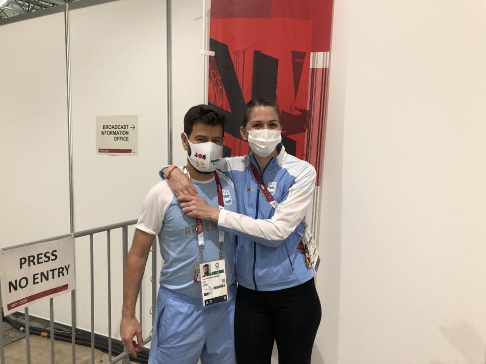 Argentine fencer María Belén Pérez Maurice, right, with coach and boyfriend Lucas Saucedo in a hallway at Makuhari Messe Hall B in Chiba, Japan on July 26, 2021. Saucedo proposed to Pérez Maurice during a television interview after her loss in the opening round of women's sabre competition at the Tokyo Olympics.