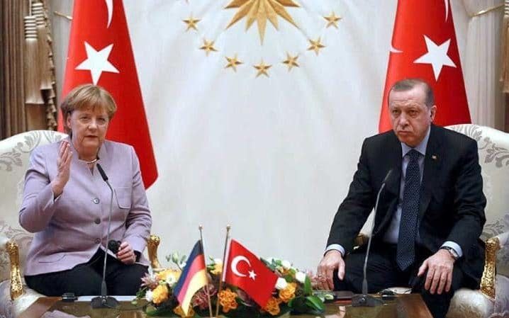 Recep Tayyip Erdogan with Angela Merkel at the Presidential Palace in Ankara in February, 2017 - AFP