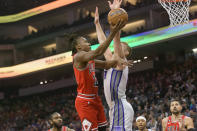 Chicago Bulls guard Ayo Dosunmu, left, drives to the basket past Sacramento Kings forward Domantas Sabonis during the first quarter of an NBA basketball game in Sacramento, Calif., Sunday, Dec. 4, 2022. (AP Photo/Randall Benton)