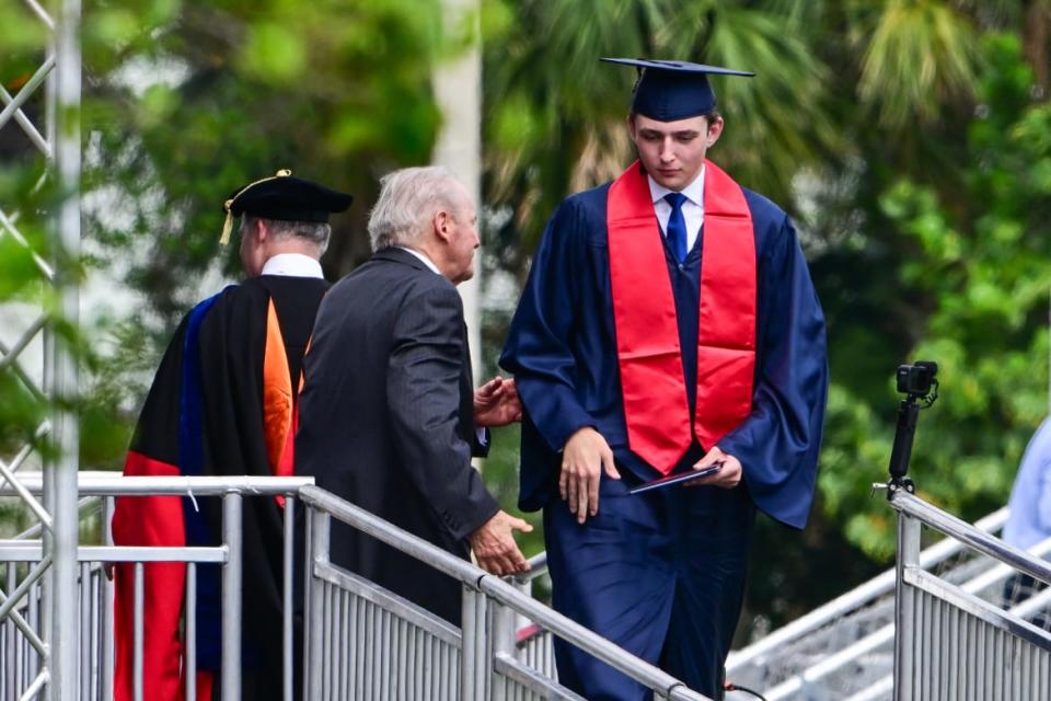 Barron Trump, son of former US President Donald Trump and former First Lady Melania Trump, takes part in his graduation at Oxbridge Academy in Palm Beach, Florida, May 17, 2024. 