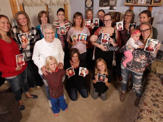 Jan Parker, surrounded by 17 daughters and granddaughters who have worn the same red plaid dress for their elementary school photos. (Photo: Chad Nelson, KARE 11)