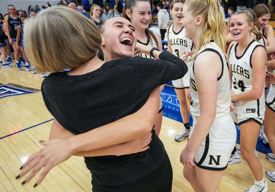 Noblesville Millers guard Reagan Wilson (22) hugs Noblesville Millers head coach Donna Buckley after drafting the Hamilton Southeastern Royals on Saturday, Feb. 3, 2024, during the IHSAA girls basketball sectional Class 4A game at Hamilton Southeastern High School in Indianapolis. The Noblesville Millers defeated the Hamilton Southeastern Royals, 49-45.