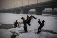 <p>Young Hindu devotees play in Yamuna river, covered by chemical foam caused due to industrial and domestic pollution, during Chhath Puja festival in New Delhi, India, Wednesday, Nov. 10, 2021. A vast stretch of one of India's most sacred rivers, the Yamuna, is covered with toxic foam, caused partly by high pollutants discharged from industries ringing the capital New Delhi. Still, hundreds of Hindu devotees Wednesday stood knee-deep in its frothy, toxic waters, sometimes even immersing themselves in the river for a holy dip, to mark the festival of Chhath Puja. (AP Photo/Altaf Qadri)</p> 