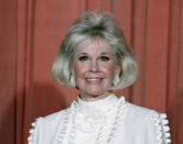 FILE - In this Jan. 28, 1989 file photo, actress and animal rights activist Doris Day poses for photos after receiving the Cecil B. DeMille Award she was presented with at the annual Golden Globe Awards ceremony in Los Angeles, Calif. Doris Day, a top box-office draw and recording artist who died in May 2019, stood for the 1950s ideal of innocence and G-rated love, a parallel world to her contemporary Marilyn Monroe. She received a Presidential Medal of Freedom in 2004. (AP Photo, File)