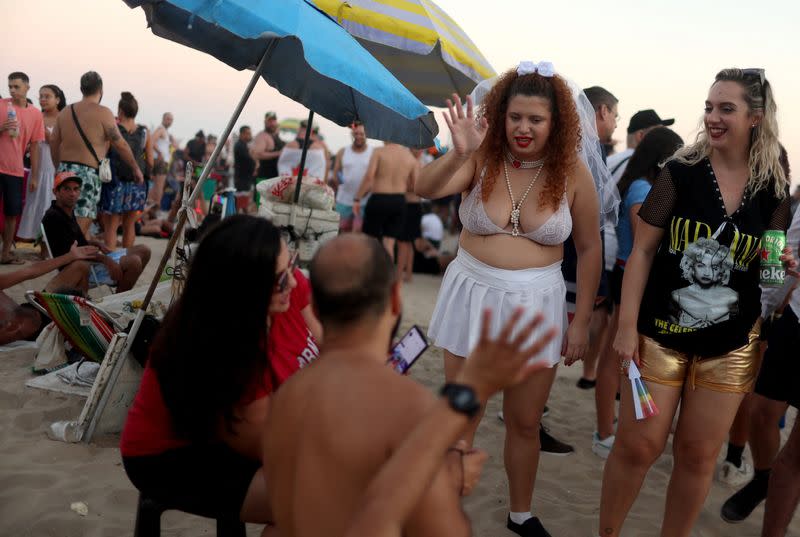 People gather for Madonna's concert at Copacabana beach, in Rio de Janeiro