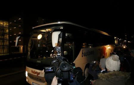 A bus with refugees arrives from the Bavarian town of Landshut to the Chancellery building in Berlin, Germany, January 14, 2016. REUTERS/Fabrizio Bensch