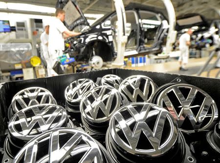 Emblems of VW Golf VII car are pictured in a production line at the plant of German carmaker Volkswagen in Wolfsburg, February 25, 2013. REUTERS/Fabian Bimmer/File Photo