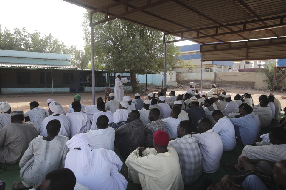 People attend Eid al-Firtr prayer in Khartoum, Sudan, Friday, April 21, 2023. Eid al-Fitr holiday, that marks the end of the holy Islamic month of Ramadan, is marked by faithful as gunshots rang out across the capital of Khartoum and heavy smoke billowed over the skyline. (AP Photo/Marwan Ali)