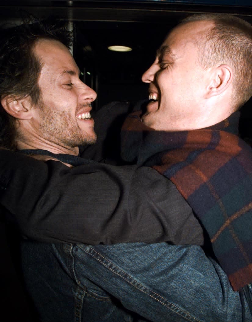 Former Neighbours stars turned actors Guy Pearce (left) and Jason Donovan, who stars in the film, hug upon arrival for the premiere of the film 'Sorted', at the ABC cinema in London's Shaftsbury Avenue.