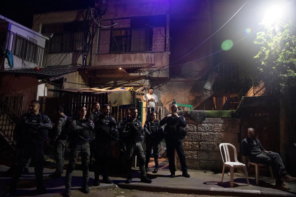 <p>Israeli police stand guard in front of a Palestinian home in the Sheikh Jarrah neighbourhood</p> (AP)