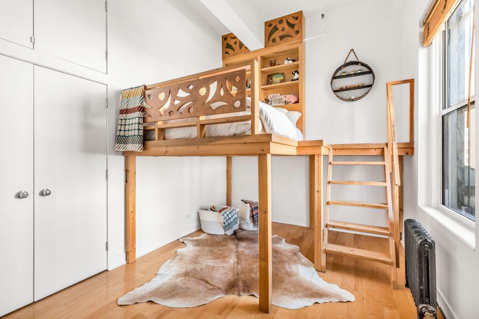 A lofted bed adds space to one room.