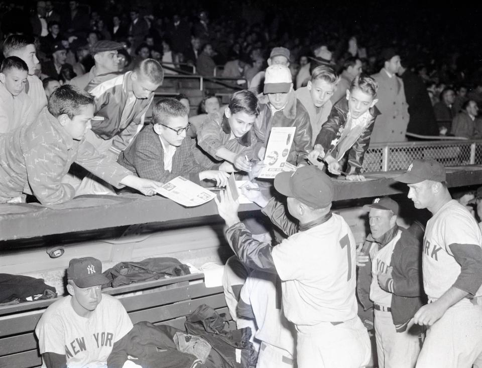 Mickey Mantle signs autographs after the Yankees lost to Cincinnati 7-5 in an exhibition game April 11, 1956, before a crowd of more than 14,000 at Jets Stadium (now Cooper Stadium) in Columbus. Mantle suffered a leg injury and had one at-bat, a pinch-hit single.