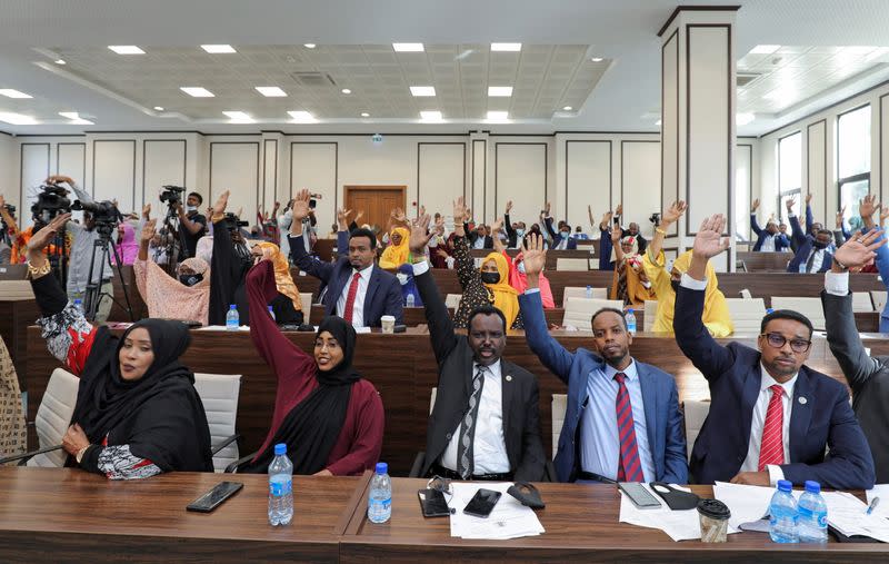 Somali legislators of the lower house of parliament raise their hands to vote to extend President Mohamed Abdullahi Mohamed's term for another two years to let the country prepare for direct elections, in Mogadishu