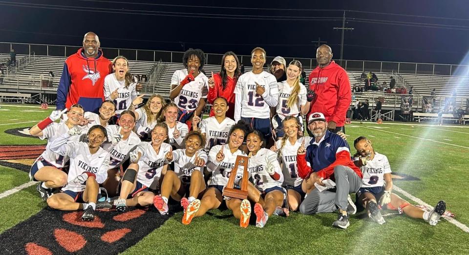 The Fort Walton Beach flag football team poses after defeating Choctaw 9-7 for the program's first-ever district championship.