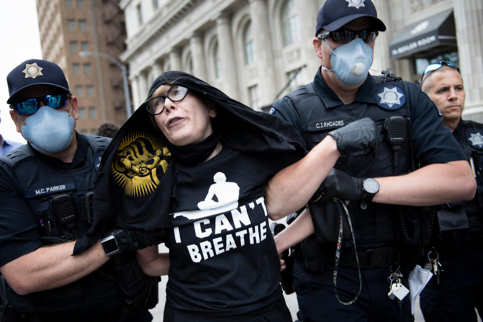 Tulsa Police take Sheila Buck into custody near an entrance to a security checkpoint for a rally with US President Donald Trump this evening at the BOK Center on June 20, 2020, in Tulsa, Oklahoma. - Hundreds of supporters lined up early for Donald Trump's first political rally in months, saying the risk of contracting COVID-19 in a big, packed arena would not keep them from hearing the president's campaign message. (Photo by Brendan Smialowski / AFP) (Photo by BRENDAN SMIALOWSKI/AFP via Getty Images)