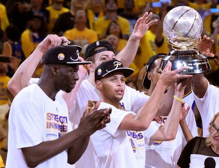 May 27, 2015; Oakland, CA, USA; (Editor's Note: Caption Correction) Golden State Warriors guard Stephen Curry (30) celebrates with the western conference championship trophy after defeating the Houston Rockets in game five of the Western Conference Finals of the NBA Playoffs at Oracle Arena. Kyle Terada-USA TODAY Sports