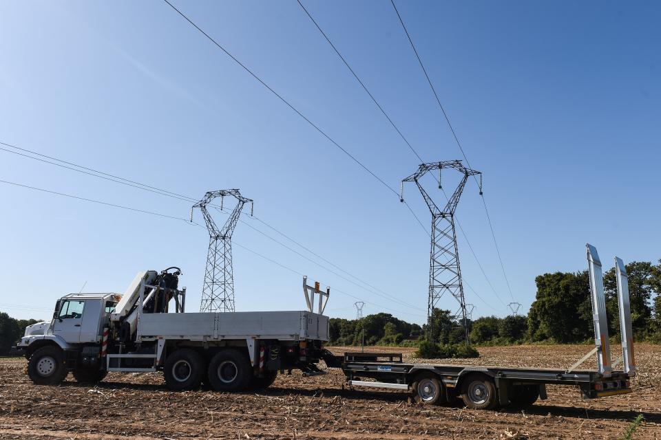 This picture taken on September 19, 2019 in Pluvigner, western France, shows a truck with a crane used to save a pilot from a power line after his F-16 fighter jet of the Belgian air force crashed. - Parts from the stricken plane, which was not carrying weapons and was flying from Belgium to a French base on a training mission, crashed into houses in the Morbihan region around the town of Pluvigner with both pilots successfully ejecting but one spending two hours hanging from a power line before being cut down, officials said. (Photo by JEAN-FRANCOIS MONIER / AFP)        (Photo credit should read JEAN-FRANCOIS MONIER/AFP/Getty Images)