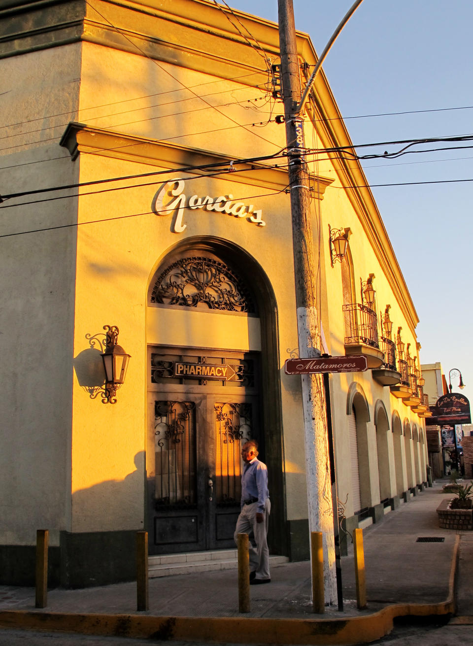 This Feb. 28, 2014 photo shows a man walking by a boarded up Garcia's souvenir shop in Matamoros, Mexico. In the midst of a three-year increase in American tourism in Mexico, communities along the Rio Grande are trying to win back U.S. tourists and revitalize their tourism industry. (AP Photo/Olga Rodriguez)