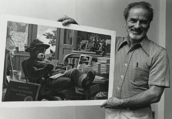 Rudy Wendelin, holding one of his works. Photo by: USDA National Agricultural Library 