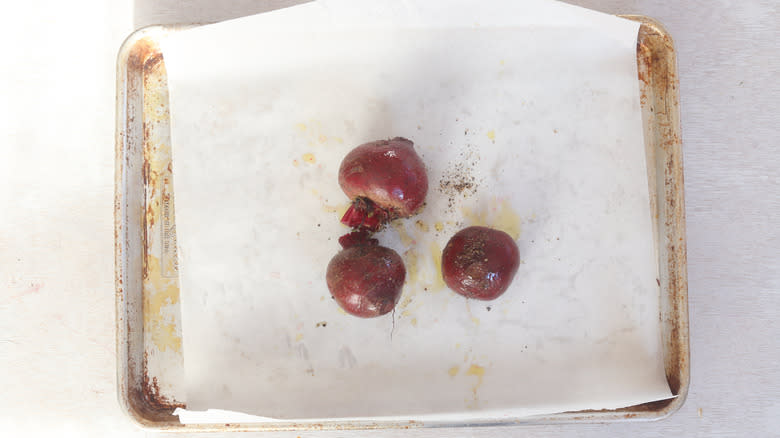 seasoned beets on parchment-lined tray