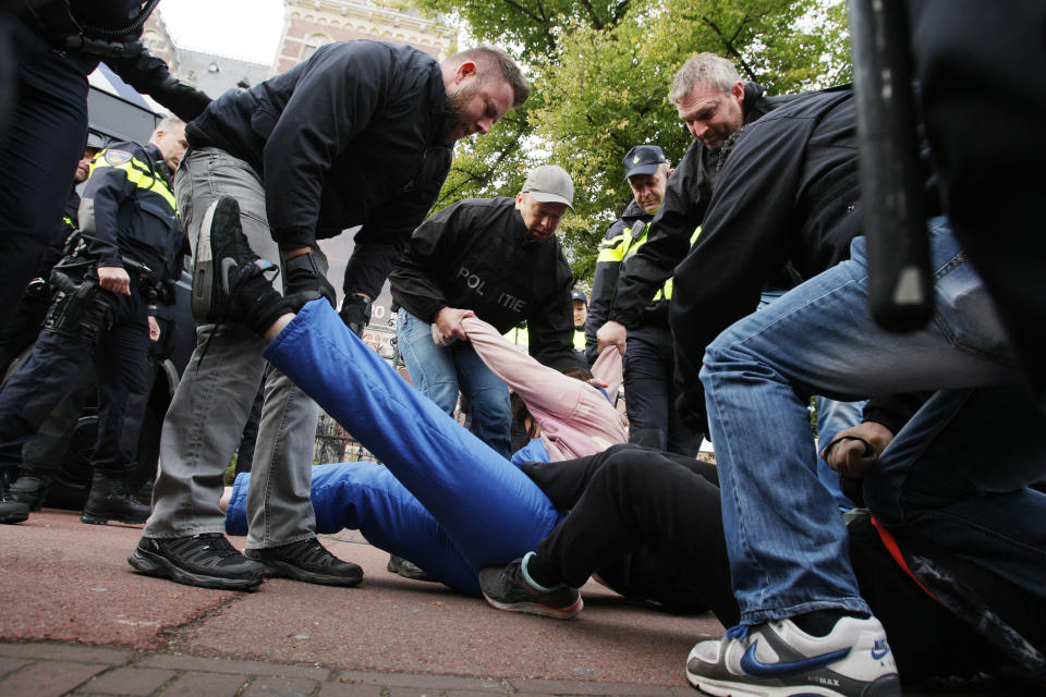 Dutch anti riot police arrested the Extinction Rebellion climate activists lie on the ground to perform a die-in action during Rebel Without Borders demonstration at the Museumbrug on Oct. 7, 2019 in Amsterdam,Netherlands. (Photo: Paulo Amorim/NurPhoto via Getty Images)