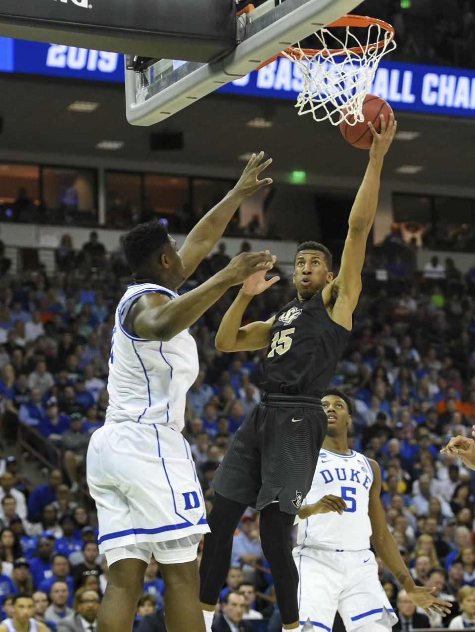 Central Florida's Aubrey Dawkins (15) shoots while defended by Duke's Zion Williamson, left, and RJ Barrett during the first half of a first round men's college basketball game in the NCAA Tournament in Columbia, S.C. Sunday, March 24, 2019. (AP Photo/Richard Shiro)