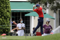 People are seen in the backyard of a home as Rory McIlroy, of Northern Ireland, tees off on the sixth hole during the final round of the Travelers Championship golf tournament at TPC River Highlands, Sunday, June 28, 2020, in Cromwell, Conn. (AP Photo/Frank Franklin II)