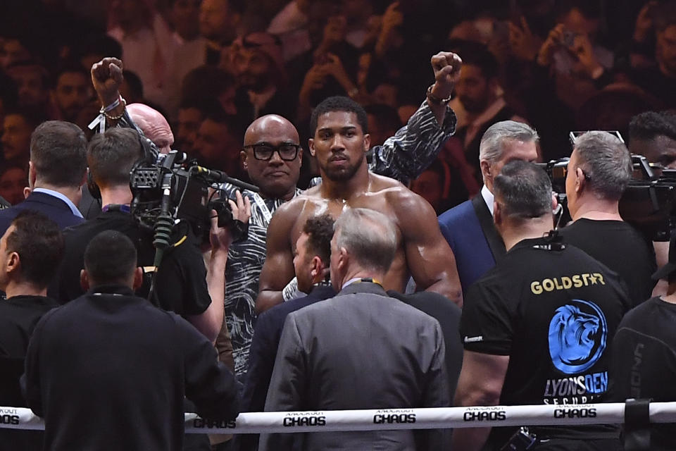 British former world champion Anthony Joshua, celebrates with his father Robert after winning the fight against Francis Ngannou during the heavyweight boxing showdown at Kingdom Arena in Riyadh, Saudi Arabia, Saturday, March 9, 2024. (AP Photo)