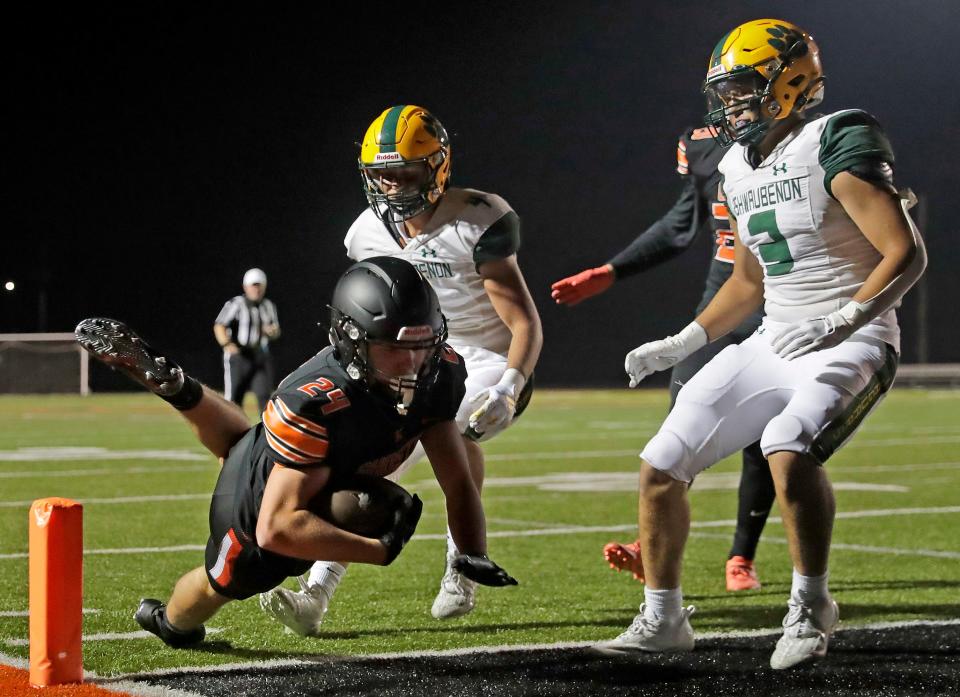 Kaukauna's Aiden Reardon (24) dives for a touchdown against Ashwaubenon during their football game Thursday in Kaukauna.