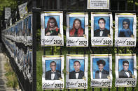 FILE - In this May 27, 2020, file photo, individual student photographs of Brooklyn's James Madison High School graduating class of 2020, who were unable to walk a graduation stage this year due to the coronavirus pandemic, line the fence around the school in New York. While New York City Mayor Bill de Blasio announced a hybrid reopen plan in the fall for the nation's largest district, Gov. Andrew Cuomo said it is up to him to decide whether schools can open at all. (AP Photo/Mark Lennihan, File)