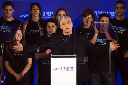 Yair Lapid (C), head of Yesh Atid party, speaks to supporters during a conference in Holon near Tel Aviv March 12, 2015. REUTERS/Amir Cohen