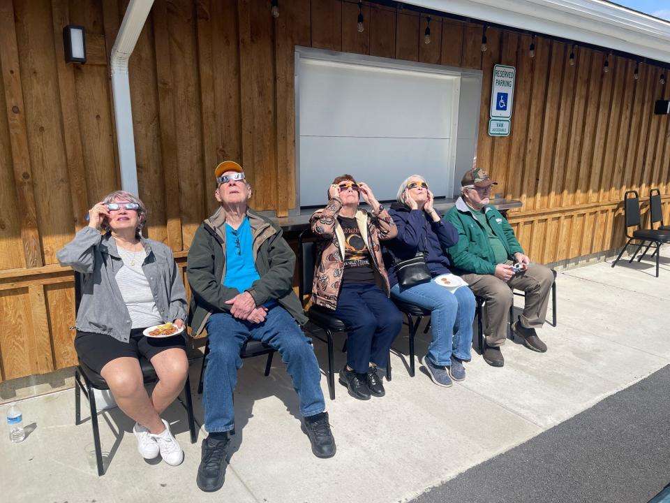 Watching the solar eclipse outside of the Grand Ballroom are, left to right, Patti McCullough, Ron Cardone and Ginny Hoenig, all of Windber, and Linda and Bill Kiraly, of Stoystown.